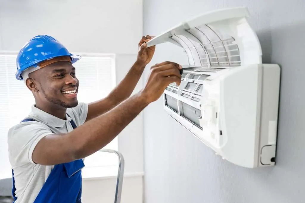 HVAC technician repairing an air conditioning unit in Phoenix, AZ.