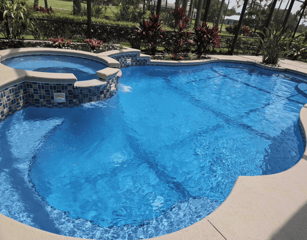 Sparkling blue pool water with newly cleaned tile and deck by Pools USA in Port St. Lucie, FL.